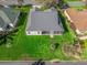 Overhead view of a home with a screened in patio, surrounded by a green lawn and landscaping at 17635 Se 82Nd Annadale Ter, The Villages, FL 32162