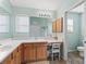 Well-lit bathroom with double vanity, generous counter space, and storage cabinets at 17635 Se 82Nd Annadale Ter, The Villages, FL 32162