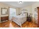 Cozy bedroom with hardwood floors, a comfortable bed, and natural light, creating a serene atmosphere at 17635 Se 82Nd Annadale Ter, The Villages, FL 32162