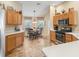 Sunlit breakfast nook with wooden cabinets, stainless steel appliances, and views to the yard at 17635 Se 82Nd Annadale Ter, The Villages, FL 32162