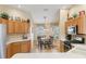 Bright breakfast nook with table seating, wooden cabinets, and stainless steel appliances at 17635 Se 82Nd Annadale Ter, The Villages, FL 32162