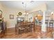 Elegant dining room adjacent to kitchen and living area with hardwood floors at 17635 Se 82Nd Annadale Ter, The Villages, FL 32162