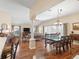 Open concept living and dining areas with hardwood floors, columns, and abundant natural light at 17635 Se 82Nd Annadale Ter, The Villages, FL 32162