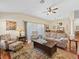 Spacious living room flows into the dining area with a traditional rug and hardwood floors at 17635 Se 82Nd Annadale Ter, The Villages, FL 32162