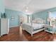 Airy main bedroom with hardwood flooring, stylish furniture, and a view of the yard at 17635 Se 82Nd Annadale Ter, The Villages, FL 32162