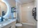 Well-lit bathroom features a vanity sink, a shower with a white tile surround, and modern fixtures at 1828 Augustine Dr, The Villages, FL 32159