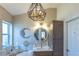 Bright bathroom showcases a marble countertop, decorative mirror, and an elegant light fixture at 1828 Augustine Dr, The Villages, FL 32159