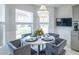 Charming breakfast nook featuring a chandelier and views of the landscaped front yard at 1828 Augustine Dr, The Villages, FL 32159