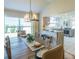 Dining room with wood table next to a kitchen with gray cabinets and marble countertops at 1828 Augustine Dr, The Villages, FL 32159