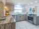 Beautiful kitchen with gray cabinetry, stainless steel appliances, and marble countertops at 1828 Augustine Dr, The Villages, FL 32159