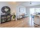 A display cabinet and decor add charm to the sunlit open-concept living and bar area with wood floors at 1828 Augustine Dr, The Villages, FL 32159