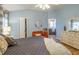 Comfortable main bedroom with wood floors, and sitting area at 1828 Augustine Dr, The Villages, FL 32159