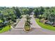 Aerial view of Loch Leven community entrance featuring lush landscaping and brick roadways at 2031 Capri Ln, Mount Dora, FL 32757