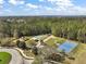 A high-angle shot of a community park with a basketball court, playground, and tennis court at 2031 Capri Ln, Mount Dora, FL 32757