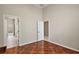 Bedroom featuring unique patterned wood floors and a doorway leading to an adjacent room at 2031 Capri Ln, Mount Dora, FL 32757