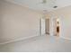 Spacious bedroom with neutral carpet, ceiling fan, and ensuite bathroom access at 2031 Capri Ln, Mount Dora, FL 32757