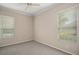 Bedroom with neutral walls, carpet, ceiling fan, and ample natural light from two windows at 2031 Capri Ln, Mount Dora, FL 32757