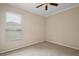 Empty carpeted bedroom with ceiling fan and large window at 2031 Capri Ln, Mount Dora, FL 32757