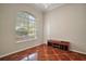 Bright bedroom showcasing a large window, hardwood floors and a wooden cabinet at 2031 Capri Ln, Mount Dora, FL 32757