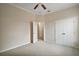 Bedroom featuring neutral walls, soft carpeting, ceiling fan, and closet at 2031 Capri Ln, Mount Dora, FL 32757