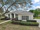 Charming single-story home with a well-manicured lawn and colorful flower beds at 2031 Capri Ln, Mount Dora, FL 32757