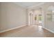 Bright living room featuring tile flooring, columns, and a doorway leading to the outdoor pool area at 2031 Capri Ln, Mount Dora, FL 32757