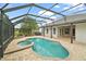 Relaxing screened-in pool area with hot tub and access to the home's outdoor patio at 2031 Capri Ln, Mount Dora, FL 32757