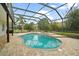 Beautiful screened-in pool and spa with brick pavers, and mature landscaping at 2031 Capri Ln, Mount Dora, FL 32757