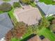 Aerial view of a home with a brown roof, surrounded by green grass and other homes at 2039 Palo Alto Ave, The Villages, FL 32159