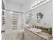 Bathroom featuring tile floors, cultured marble counters, and a tub-shower combo at 2039 Palo Alto Ave, The Villages, FL 32159