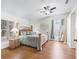 Inviting main bedroom featuring a ceiling fan, hardwood floors, and two windows at 2039 Palo Alto Ave, The Villages, FL 32159