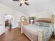 Bright primary bedroom with hardwood floors, ensuite access, and natural light at 2039 Palo Alto Ave, The Villages, FL 32159