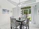 Bright dining area featuring a modern table set, large window, and stylish decor at 2039 Palo Alto Ave, The Villages, FL 32159