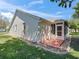 The back of a well-maintained home with green grass, rocks, and an enclosed patio at 2039 Palo Alto Ave, The Villages, FL 32159