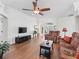 Bright and spacious living room features hardwood floors, with a ceiling fan at 2039 Palo Alto Ave, The Villages, FL 32159