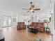 Spacious living room with wood floors and views into the kitchen and entryway at 2039 Palo Alto Ave, The Villages, FL 32159