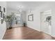 Inviting living room with wood flooring, a large window, and a glimpse of the open kitchen at 2039 Palo Alto Ave, The Villages, FL 32159