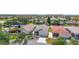 Aerial view of a residential neighborhood featuring mature landscaping, manicured lawns, and various roof styles at 2058 Thornton Ter, The Villages, FL 32162