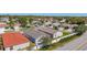 An aerial view of a residential neighborhood featuring well-maintained homes and lush landscaping at 2058 Thornton Ter, The Villages, FL 32162