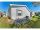 Backyard featuring vinyl siding, manicured lawn, and clean landscaping at 2058 Thornton Ter, The Villages, FL 32162