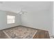 Bright bedroom featuring wood floors, a ceiling fan, and large area rug at 2058 Thornton Ter, The Villages, FL 32162