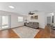 The living room features hardwood floors, a ceiling fan, recessed lighting, and a sliding door to the outside at 2058 Thornton Ter, The Villages, FL 32162