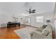 Bright living room featuring wood floors, a modern ceiling fan, dining table, and an open floor plan at 2058 Thornton Ter, The Villages, FL 32162