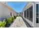 Exterior walkway features lush landscaping and leads to a table at 2058 Thornton Ter, The Villages, FL 32162