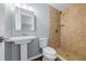 A bathroom with a pedestal sink and stand-up shower at 211 Sara Ln, Leesburg, FL 34748