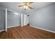 The primary bedroom offers a walk-in closet, laminate floors and neutral paint at 211 Sara Ln, Leesburg, FL 34748