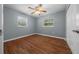 This bedroom has laminate floors, neutral paint and 2 windows for natural light at 211 Sara Ln, Leesburg, FL 34748