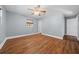 This bedroom offers sleek hard floors, neutral walls and a ceiling fan at 211 Sara Ln, Leesburg, FL 34748