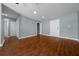 Spacious living room featuring wood floors, neutral paint, closet storage and a front door for easy access at 211 Sara Ln, Leesburg, FL 34748