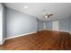 Spacious living room featuring wood floors, light gray walls, recessed lighting, and a ceiling fan at 211 Sara Ln, Leesburg, FL 34748